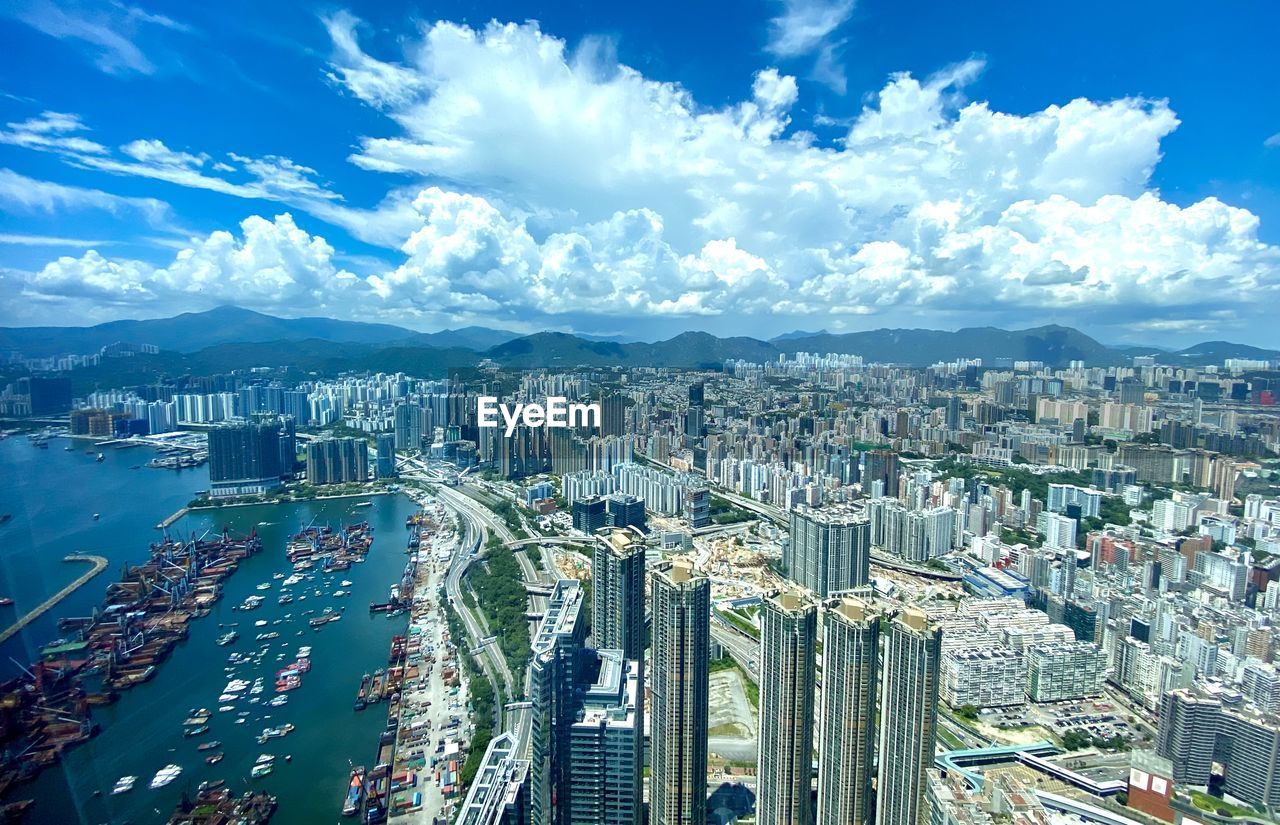 HIGH ANGLE VIEW OF MODERN CITY BUILDINGS AGAINST SKY