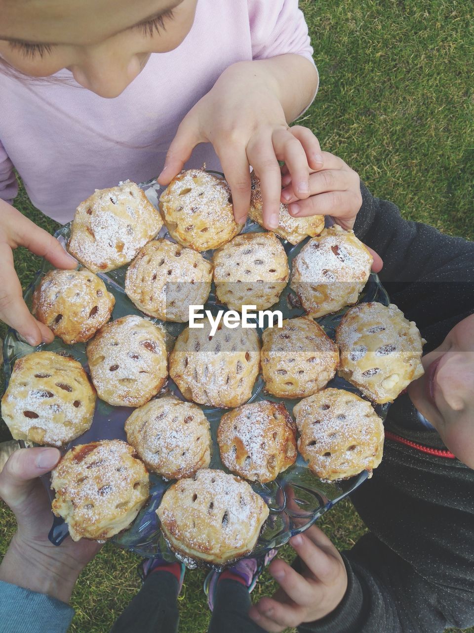 People holding cookies in tray