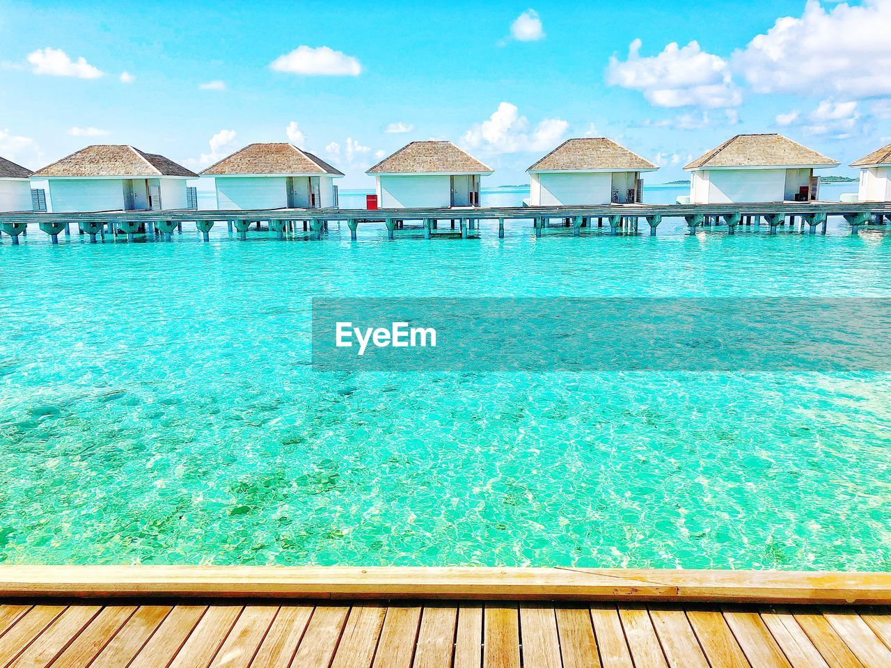 HOUSES BY SWIMMING POOL AGAINST SEA