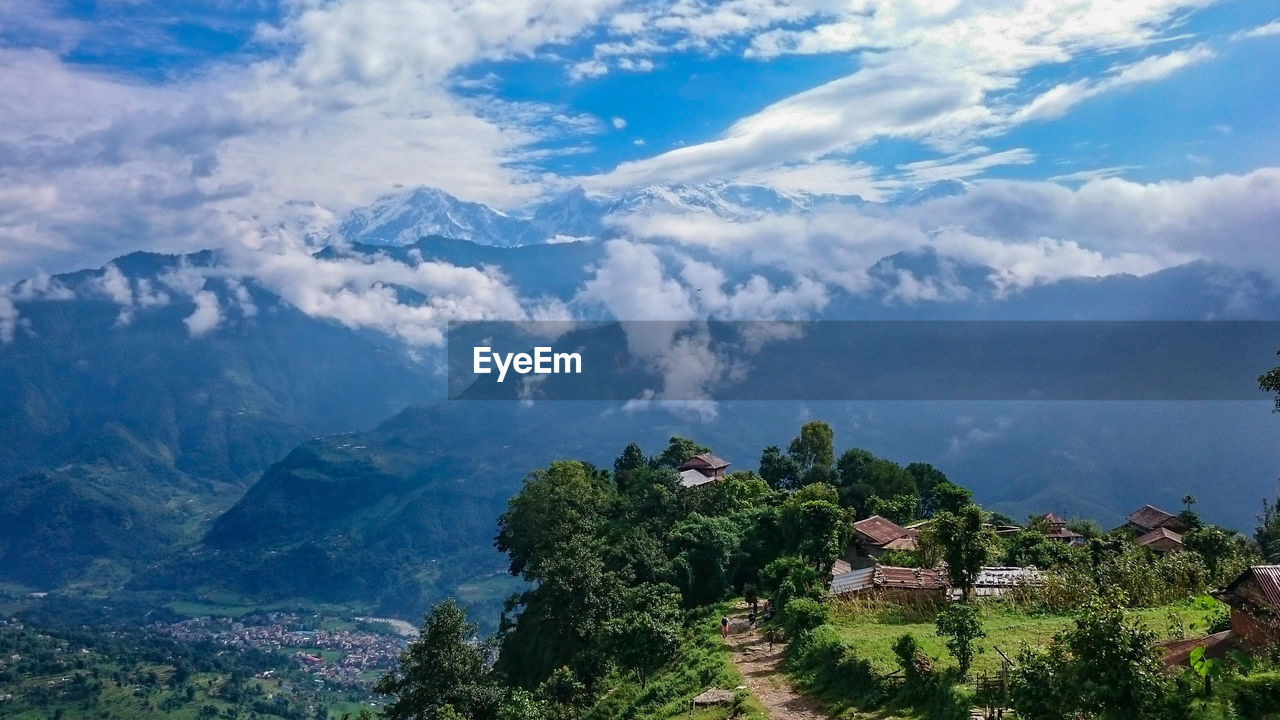 Scenic view of mountain against cloudy sky during sunny day