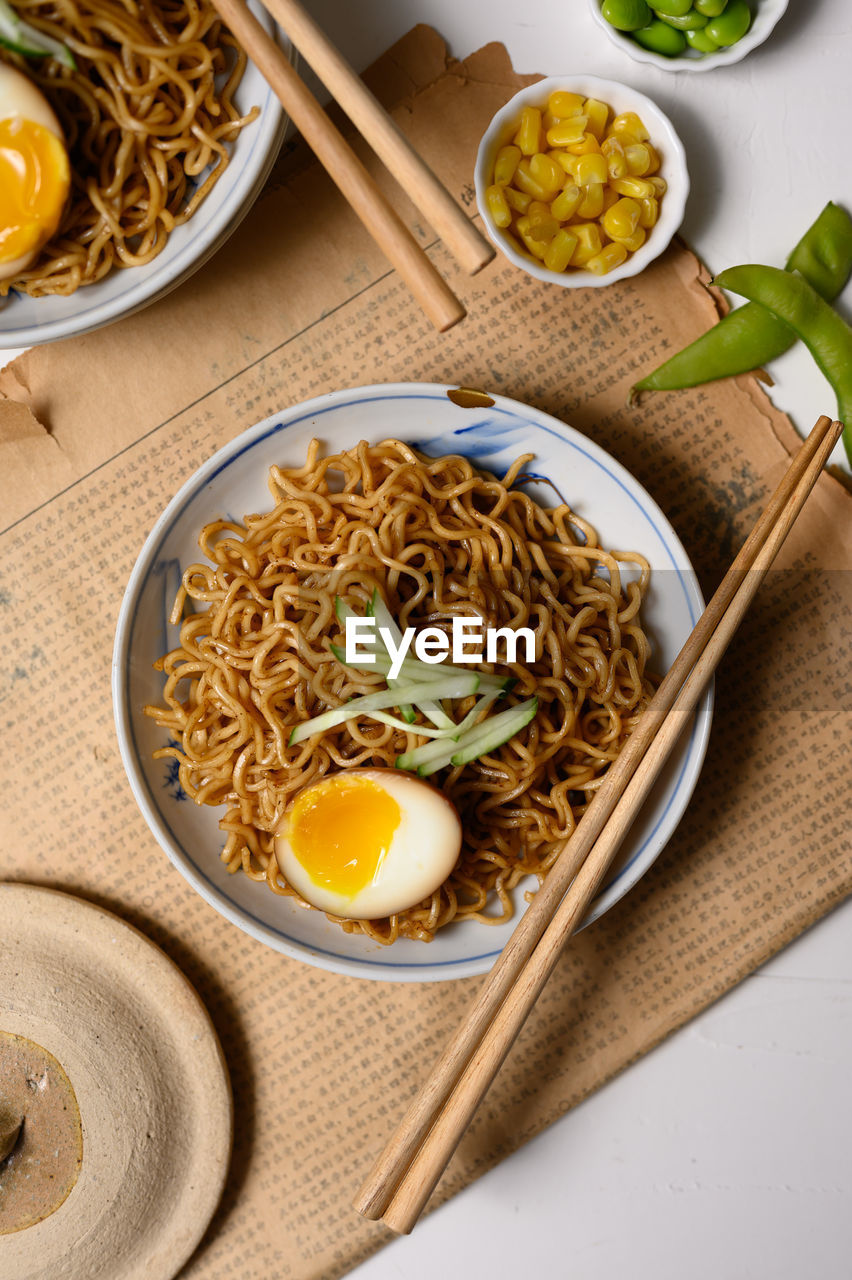 High angle view of noodles with egg served on table