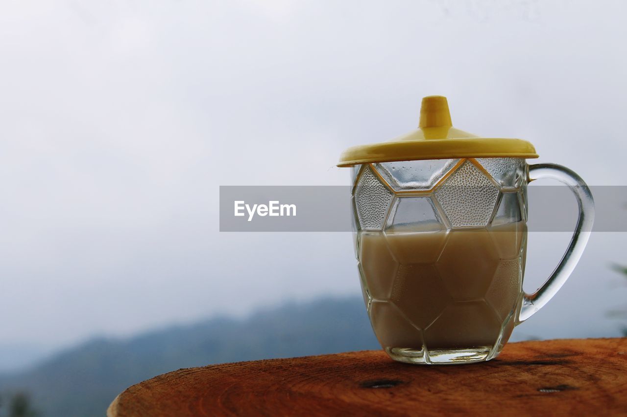 Close-up of milk cup on table