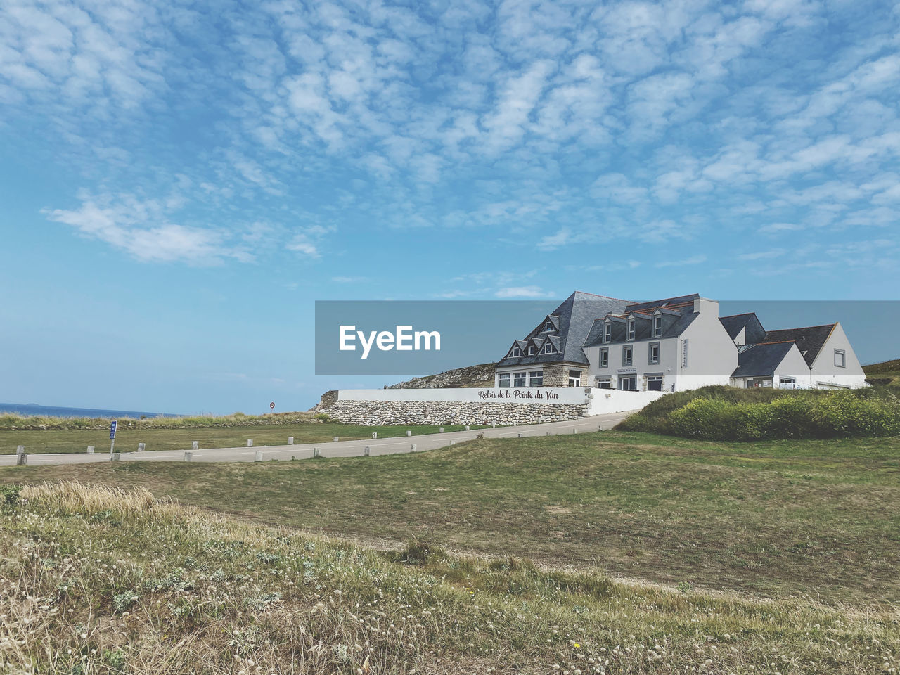 architecture, built structure, sky, building exterior, cloud, nature, history, land, grass, the past, landscape, building, rural area, no people, plant, hill, travel destinations, environment, coast, travel, day, house, blue, scenics - nature, field, outdoors, sea, tourism, rural scene, beauty in nature