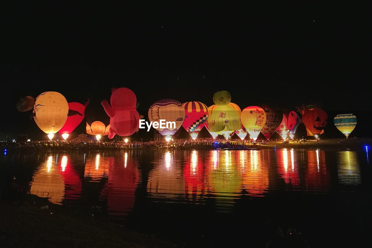 ILLUMINATED LANTERN AGAINST SKY AT NIGHT