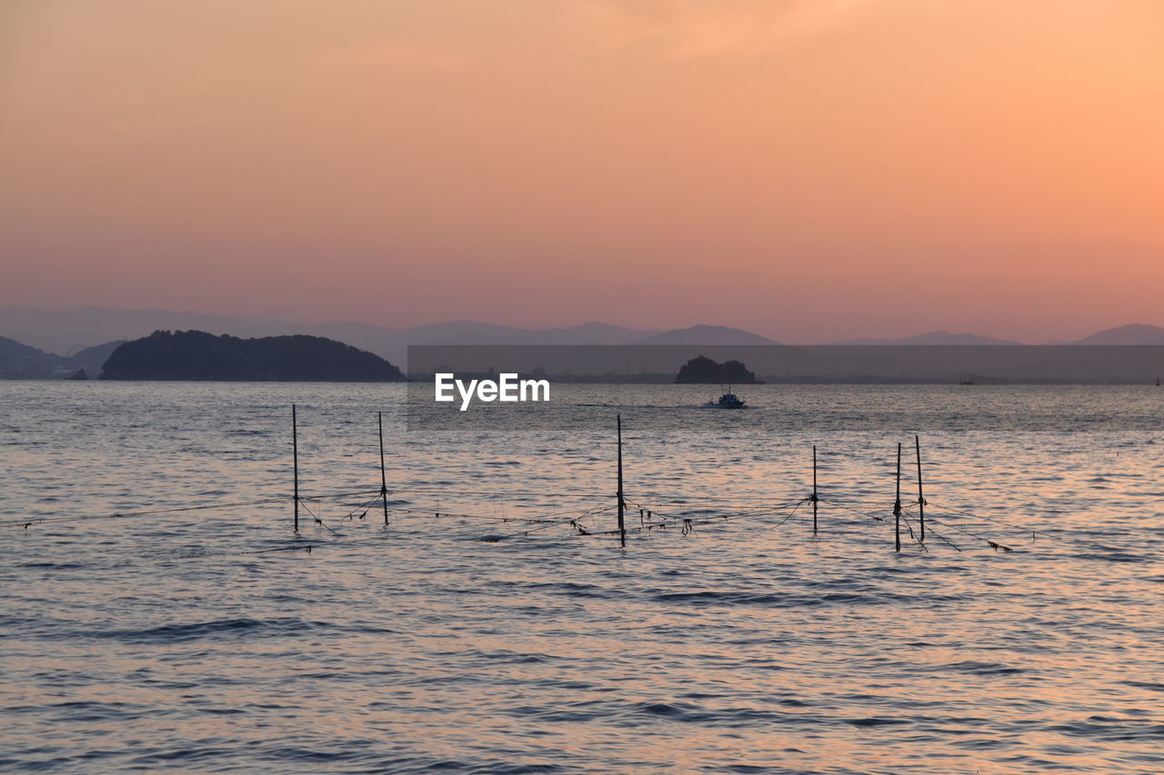 SCENIC VIEW OF SEA DURING SUNSET