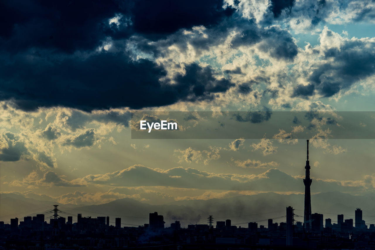 cityscape against cloudy sky