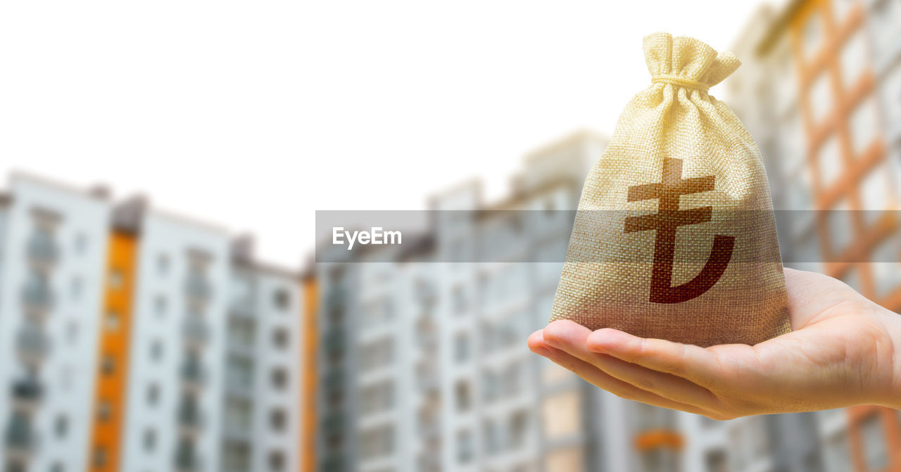 Turkish lira bag against the background of modern high-rise buildings. investing in the purchase 