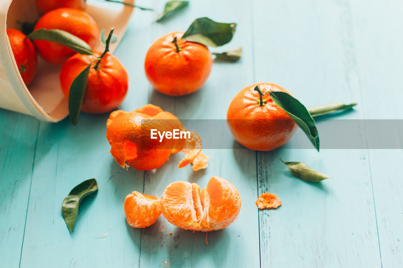 High angle view of oranges on blue table