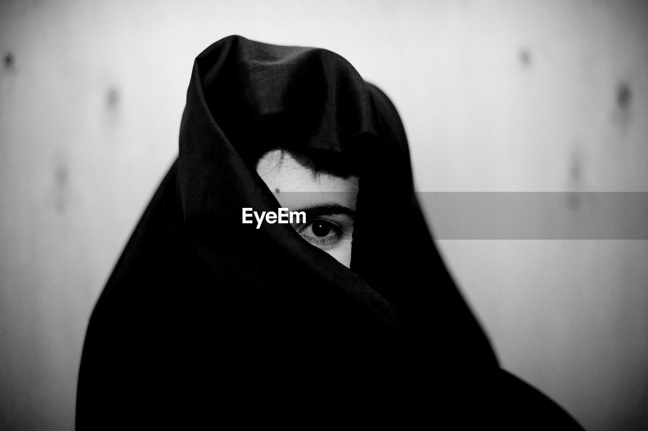 Close-up of woman in burka against wall