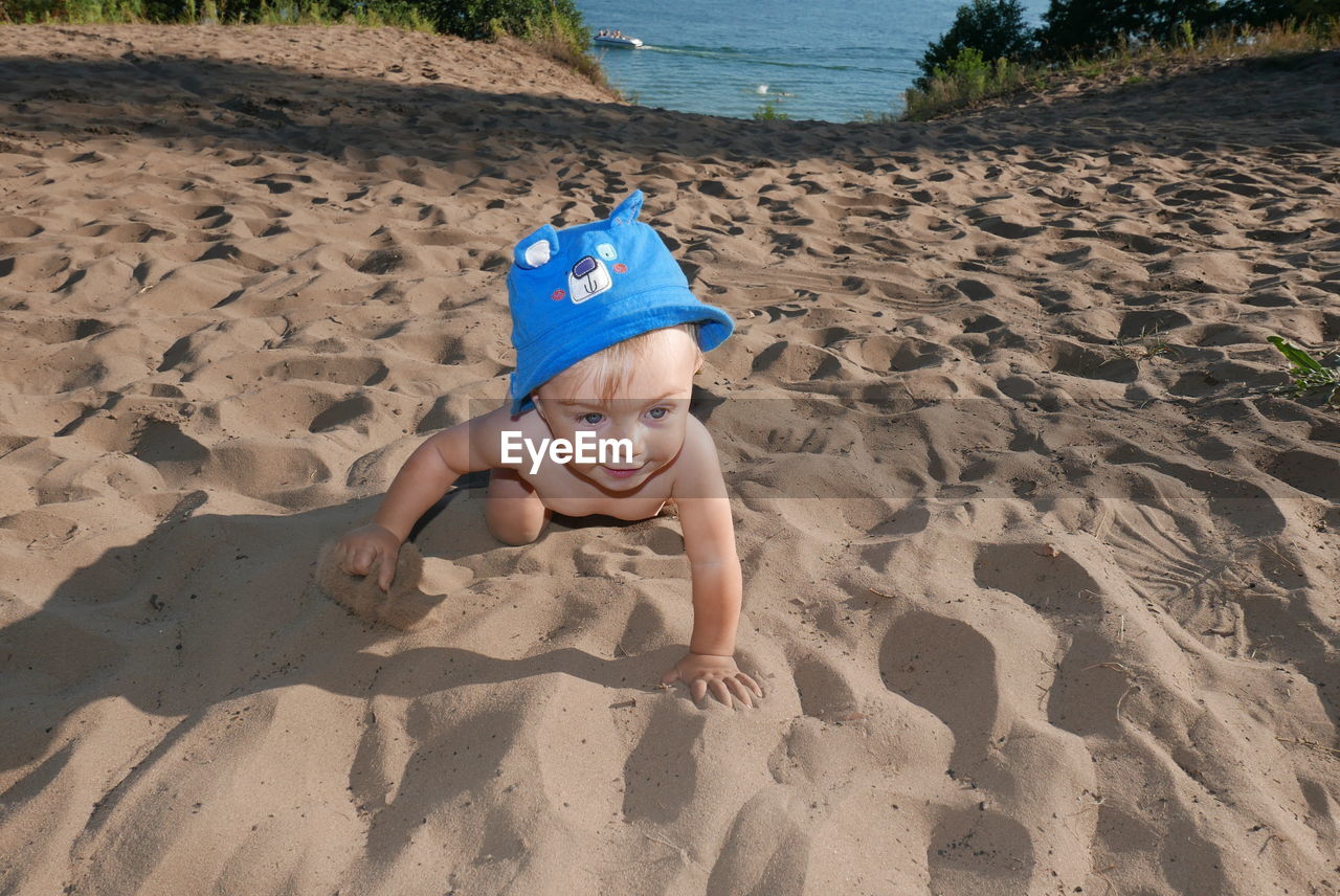 HIGH ANGLE VIEW OF FATHER AND SON ON BEACH