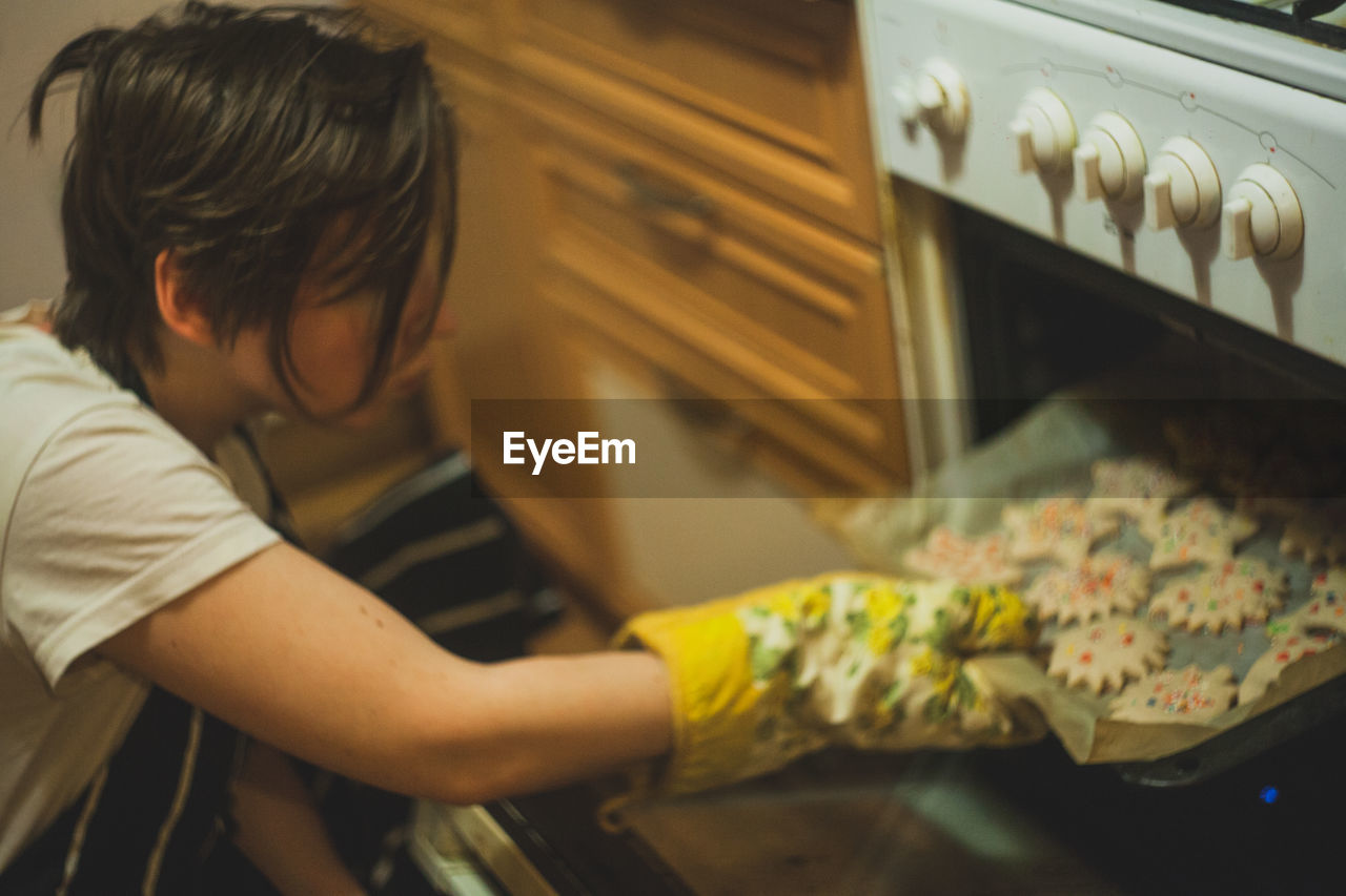 Woman putting cookies in mircrowave