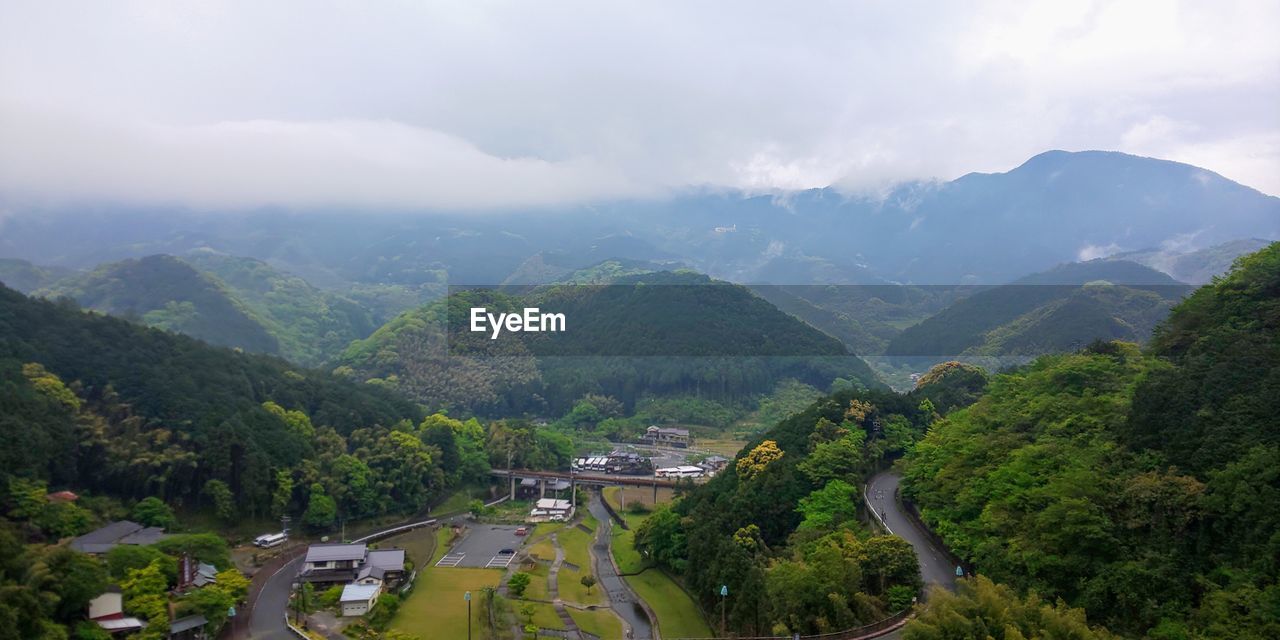 Scenic view of trees and mountains against sky