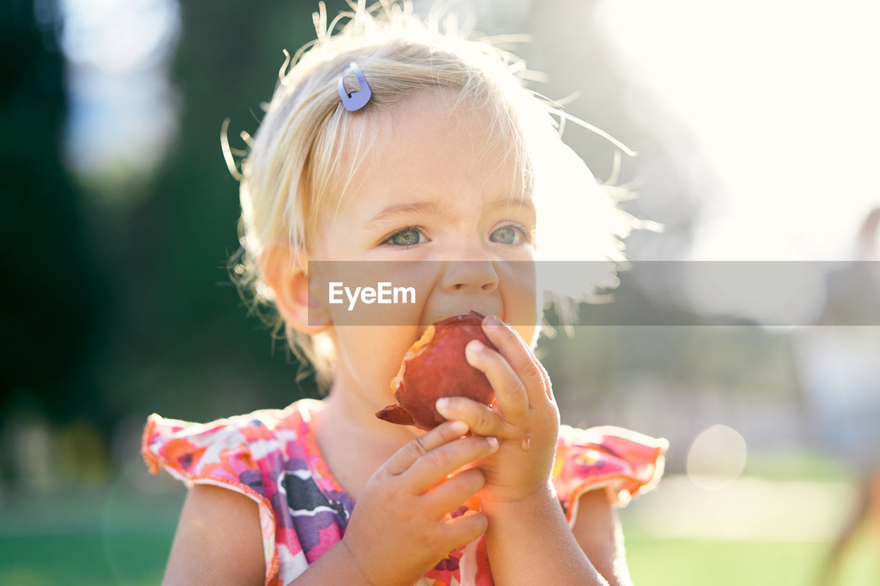 Portrait of cute girl eating food