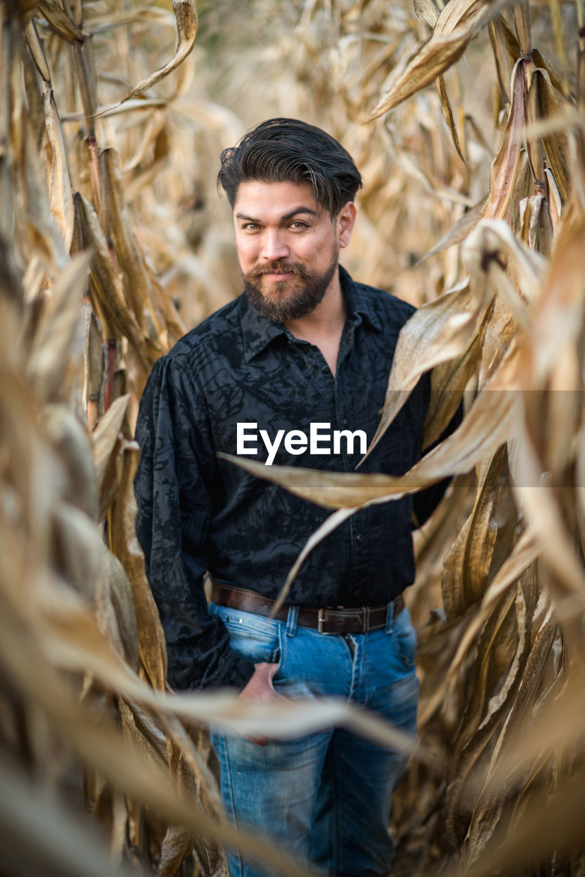 YOUNG MAN STANDING IN A FARM