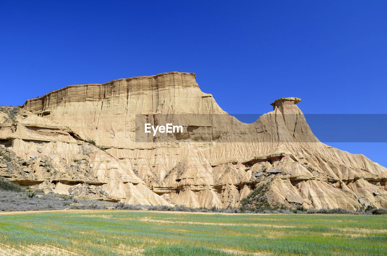 SCENIC VIEW OF ROCK FORMATION AGAINST CLEAR BLUE SKY