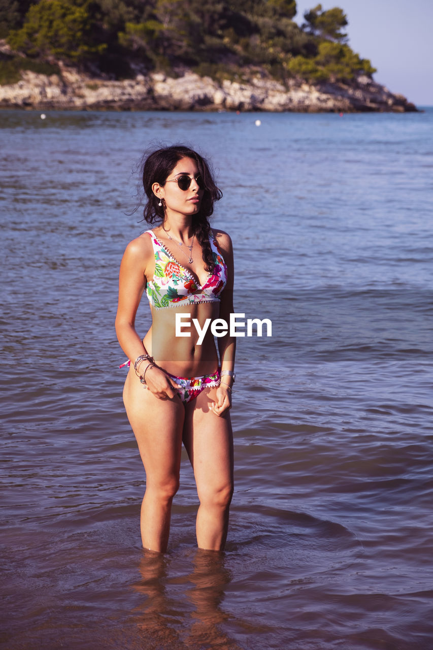 Portrait of woman standing in sea