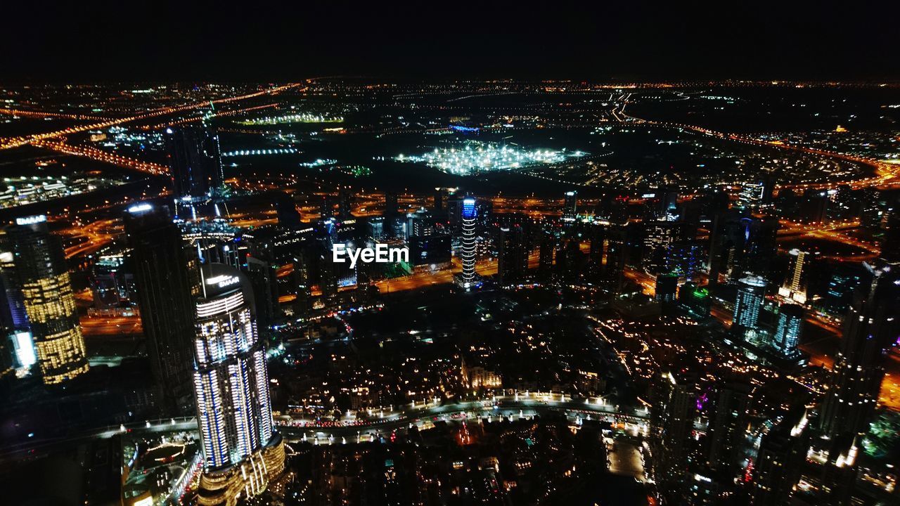 High angle view of illuminated city buildings at night