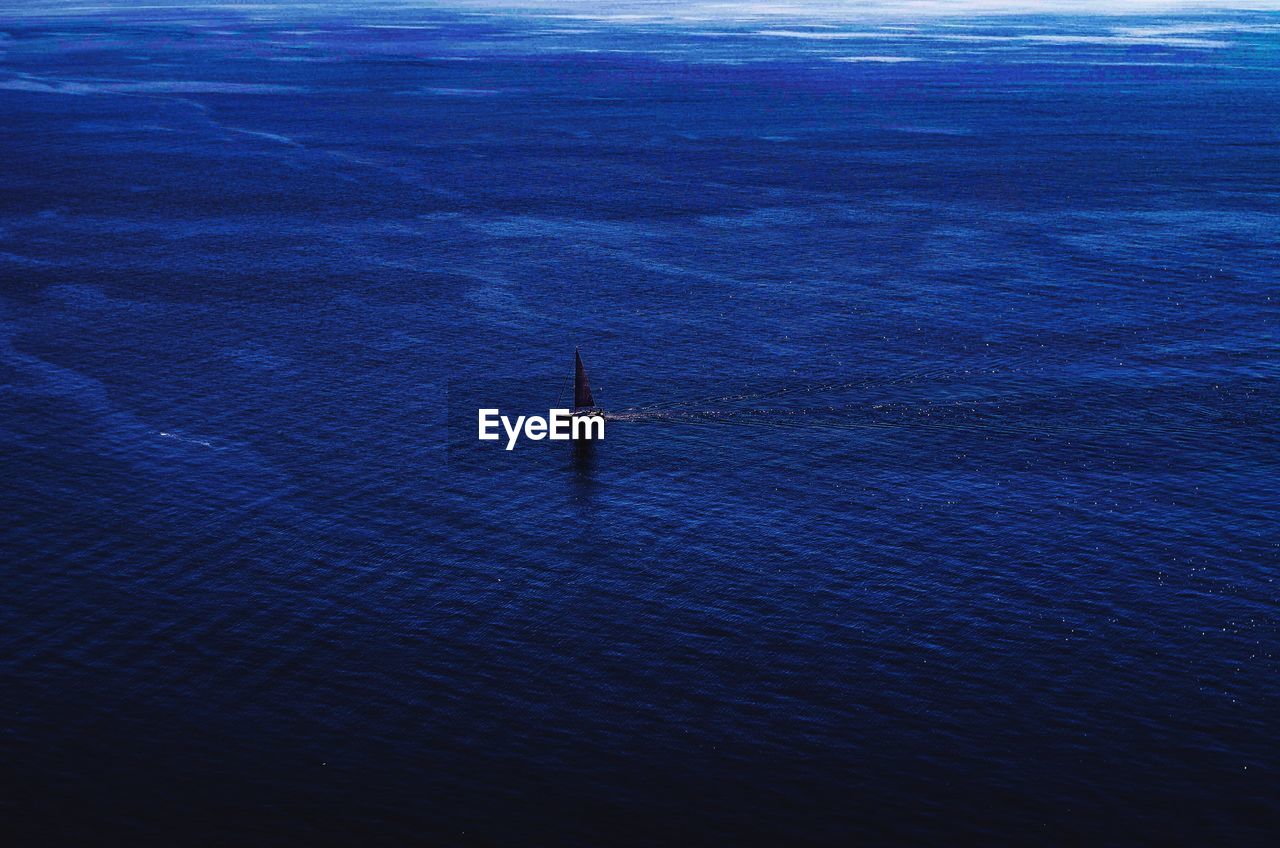 High angle view of sailboat sailing in sea against sky