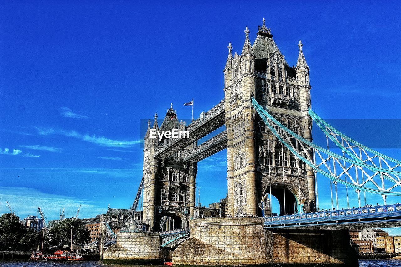 Low angle view of tower bridge against blue sky