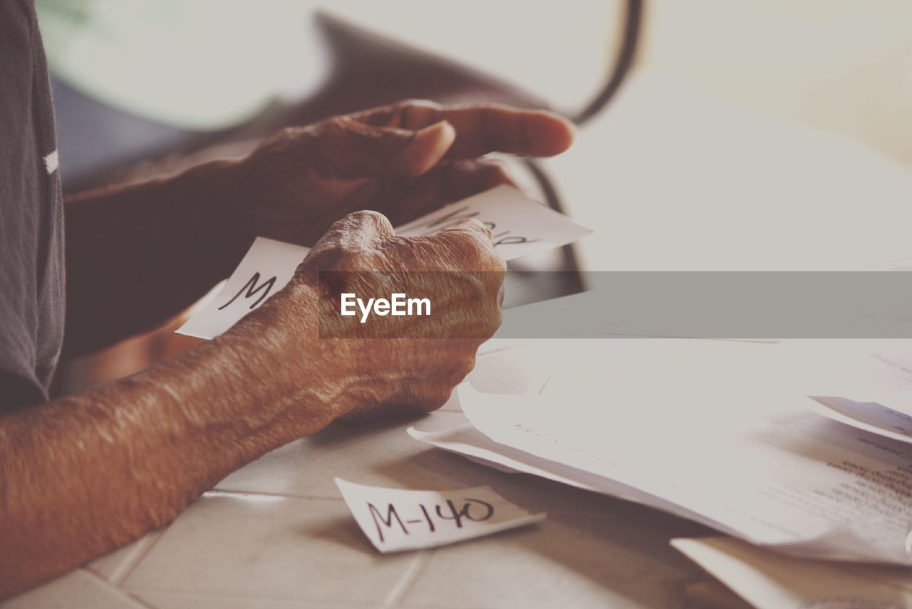 Cropped image of man holding papers