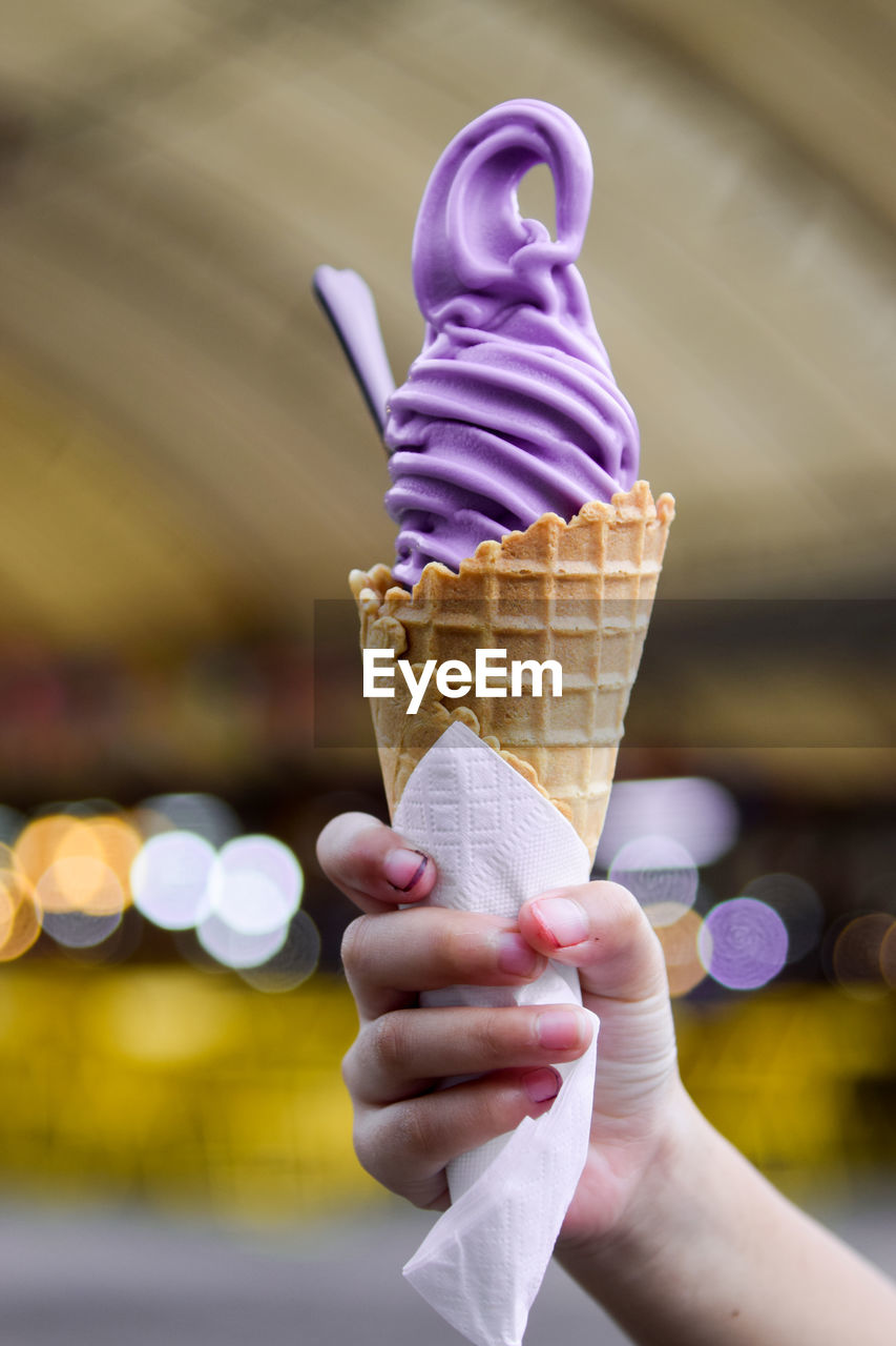 Cropped hand of woman holding ice cream cone