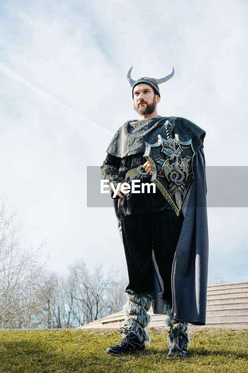 Full length of man in costume standing against sky