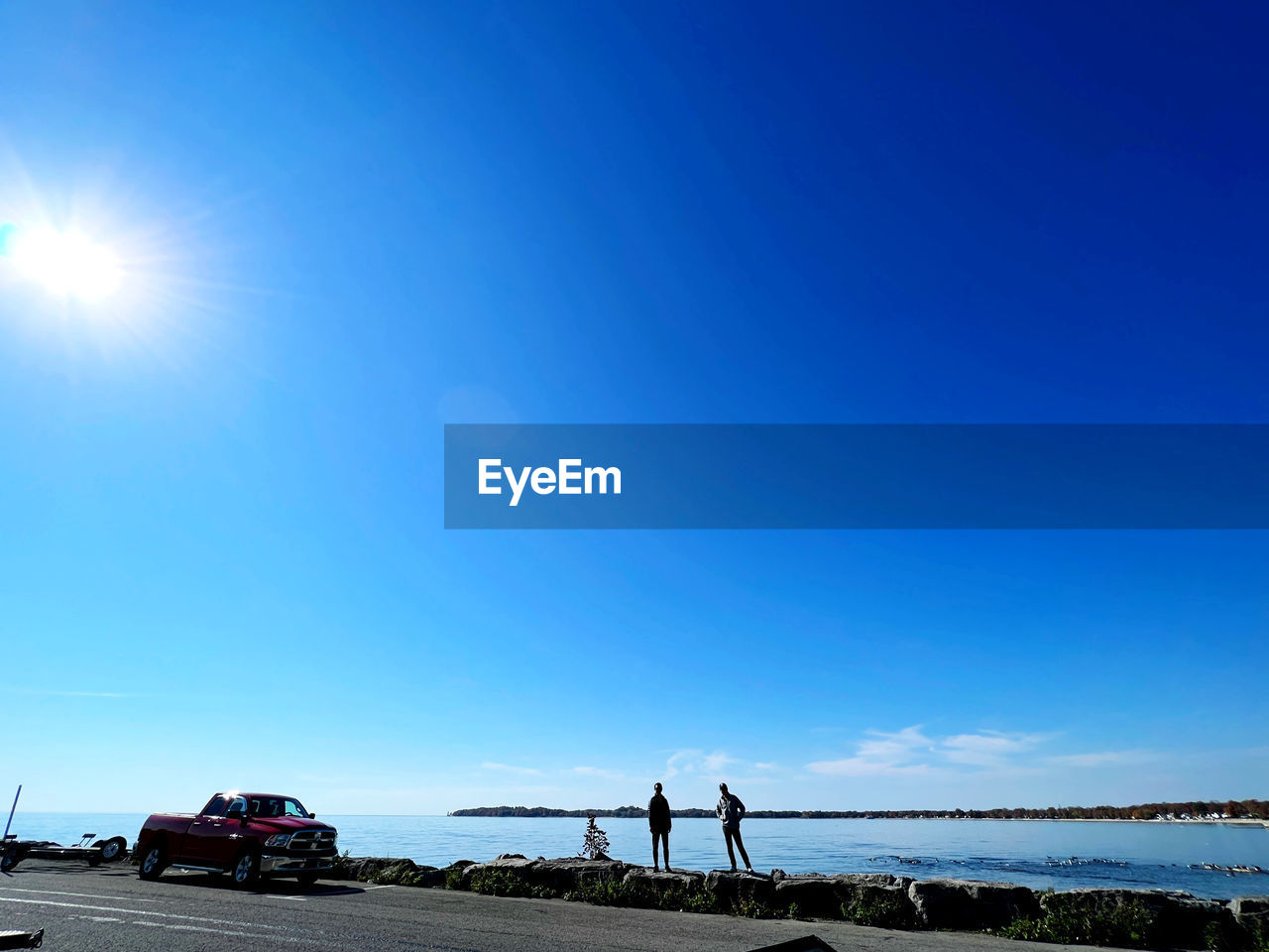 horizon, sky, blue, transportation, nature, mode of transportation, water, sunlight, sea, motor vehicle, dusk, car, travel, sun, clear sky, sunny, land vehicle, vehicle, copy space, day, land, cloud, morning, beach, beauty in nature, road, ocean, lens flare, outdoors, shore, scenics - nature, coast, travel destinations, environment, motion, vacation, trip, summer, holiday, sunbeam, architecture