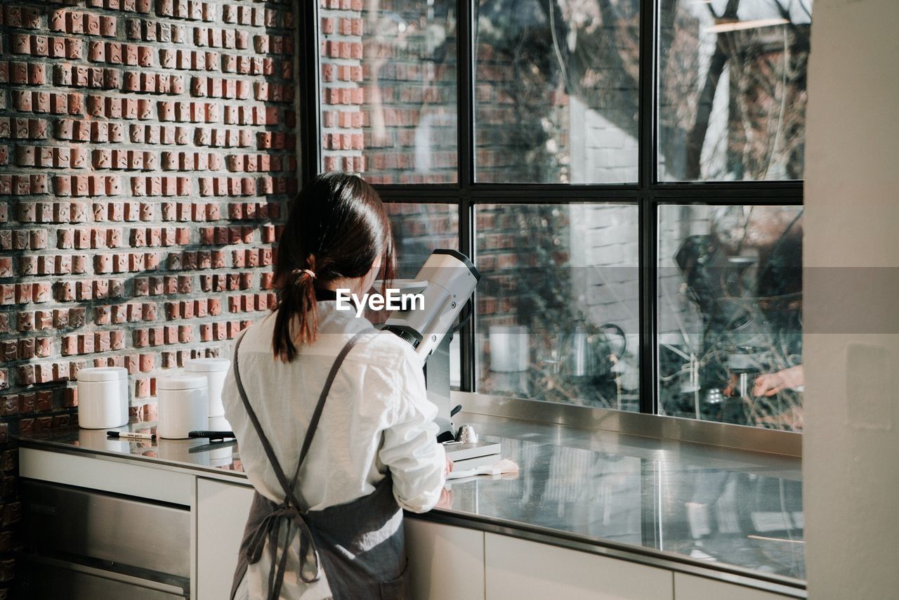 WOMAN USING PHONE IN OFFICE