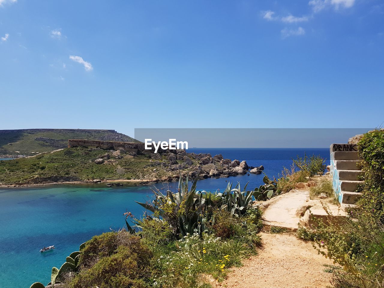 Scenic view of sea against blue sky