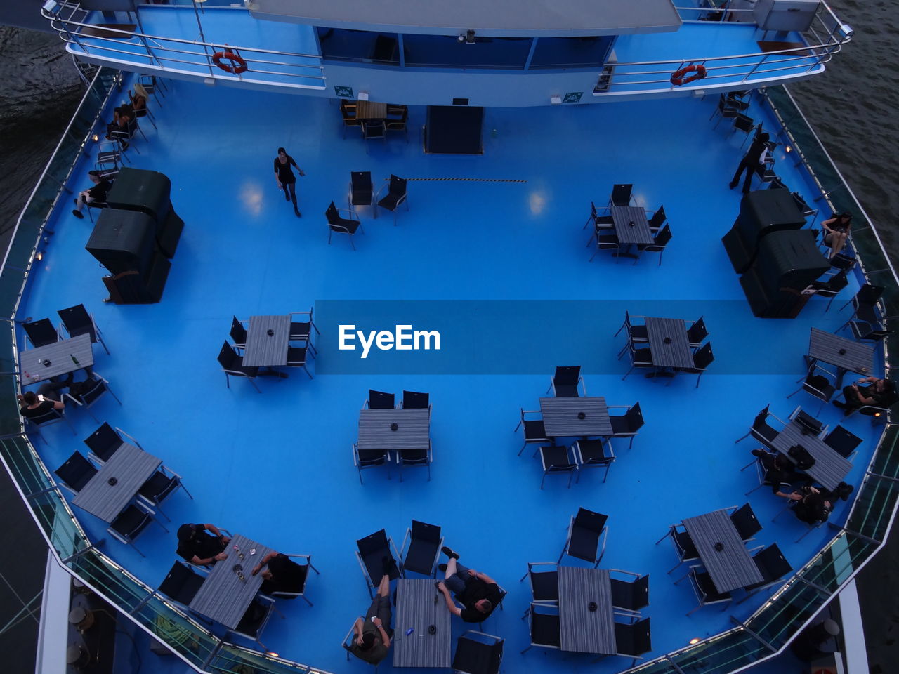 High angle view of people on boat deck in the evening