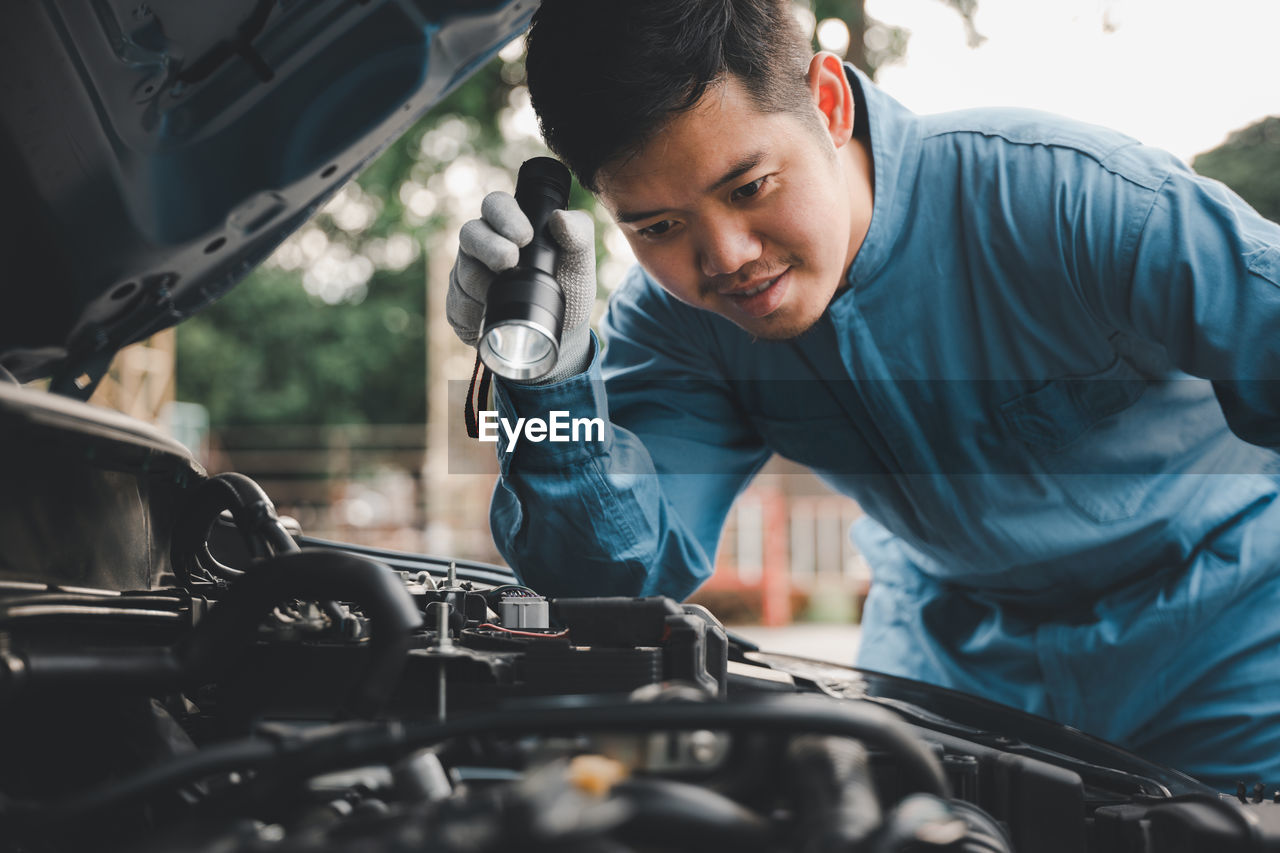 side view of man working in car