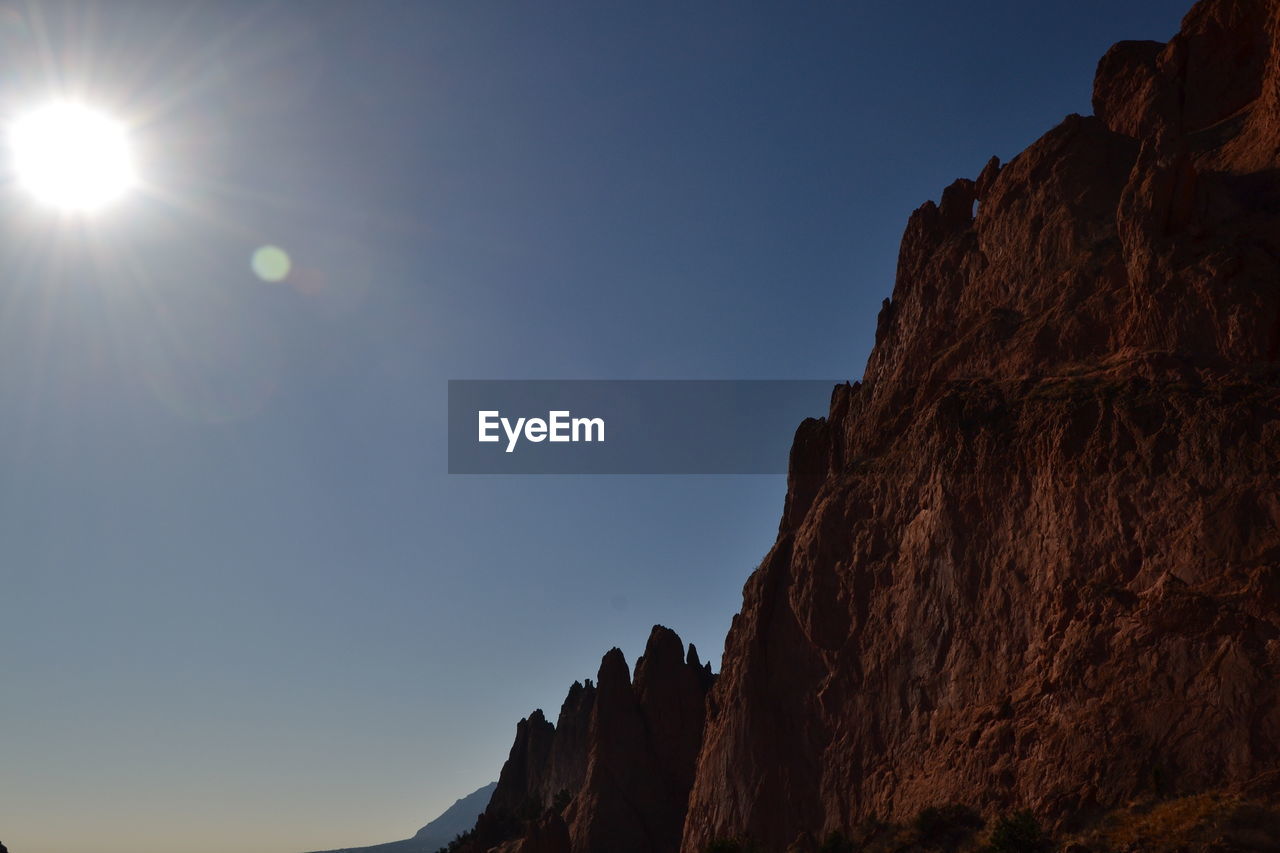 Low angle view of rock formations against sky