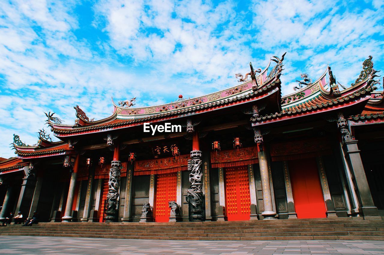 TEMPLE AGAINST CLOUDY SKY