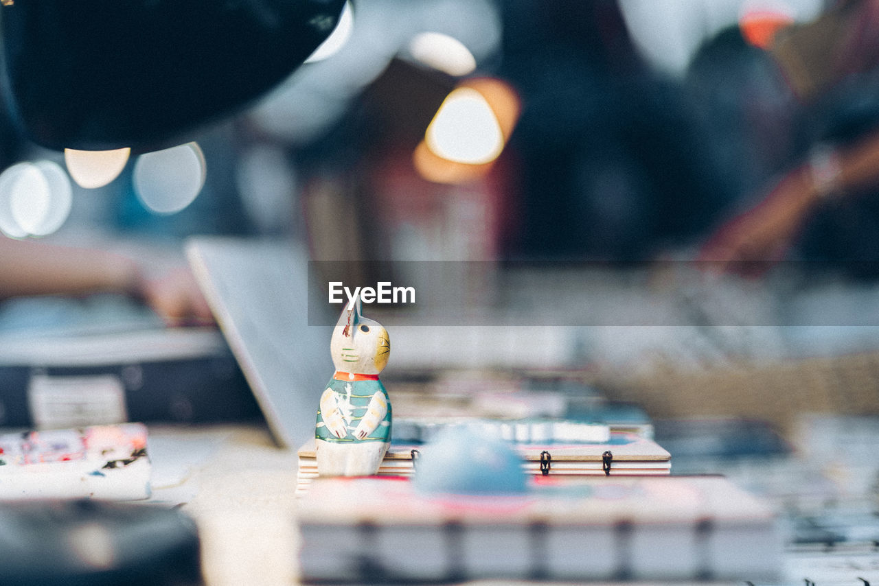 Close-up of figurine on office table