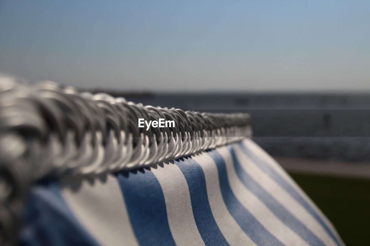 Close-up of textile against sea and clear sky