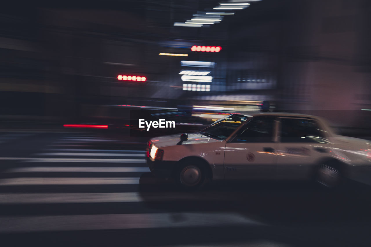 Blurred motion of car on road at night