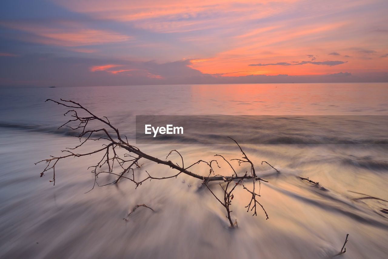 Scenic view of sea against sky at sunset