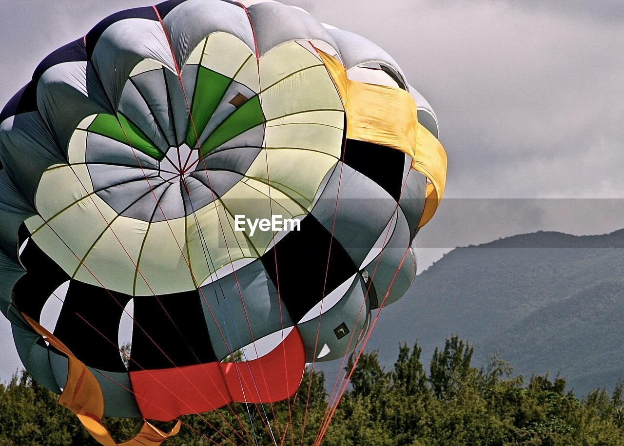 LOW ANGLE VIEW OF HOT AIR BALLOON ON LANDSCAPE