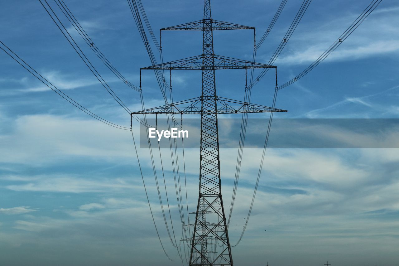 Low angle view of electricity pylon against sky