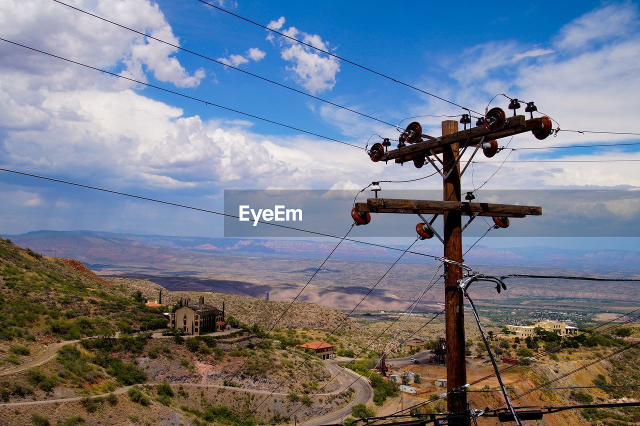 ELECTRICITY PYLON AGAINST SKY