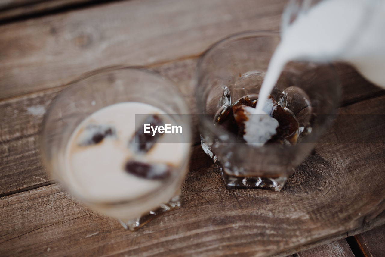 High angle view of coffee being poured on table