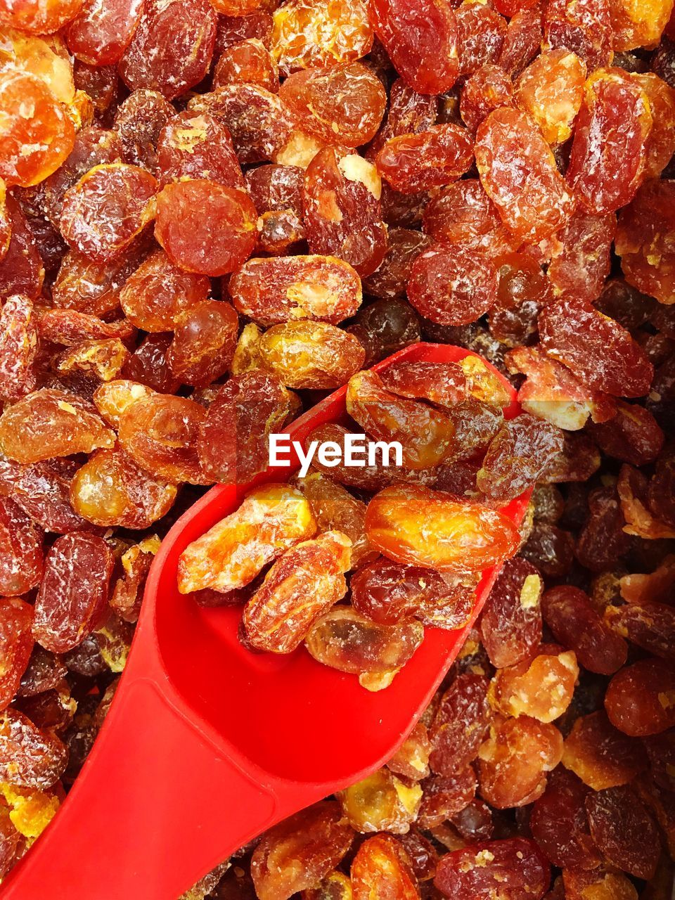 Close-up of red spoon on raisins