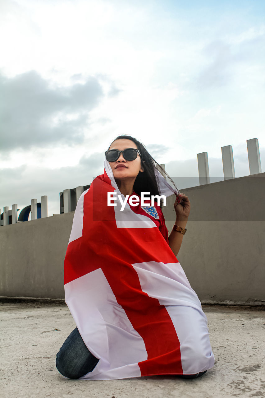 The three lions supporter with england's away kit and flag of st.george cross.