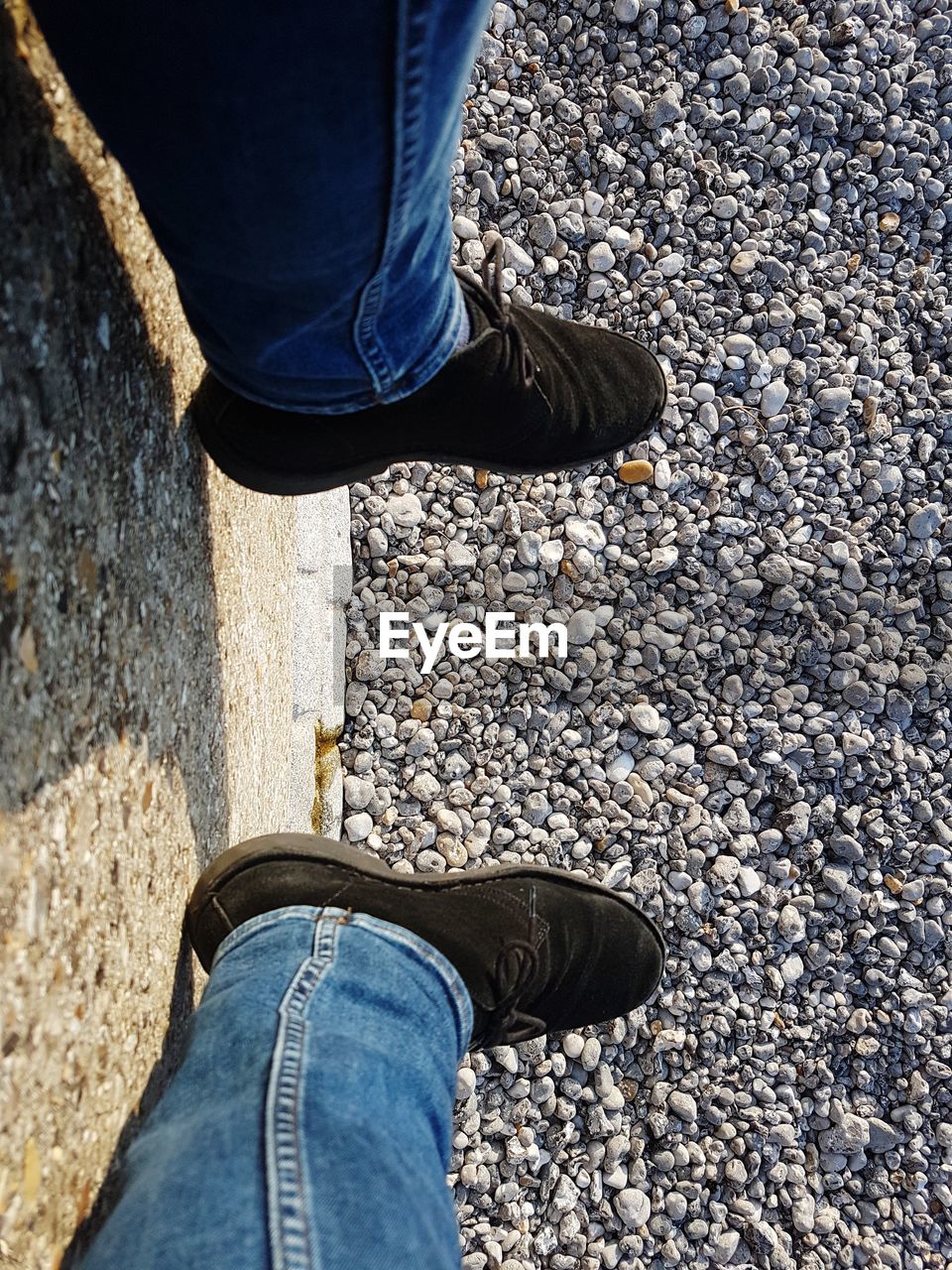 LOW SECTION OF MAN STANDING ON STONE