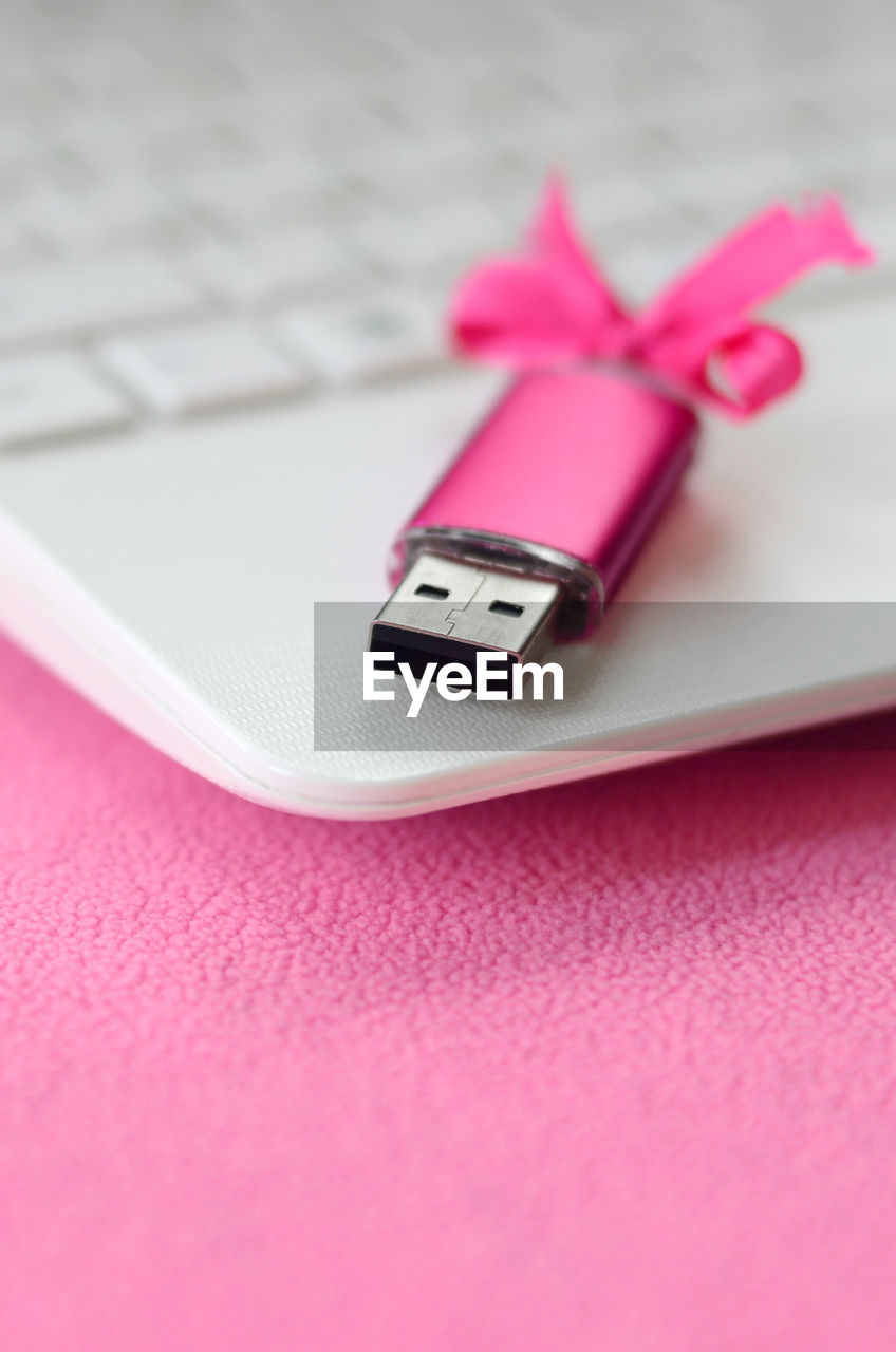 Close-up of usb stick and laptop on table