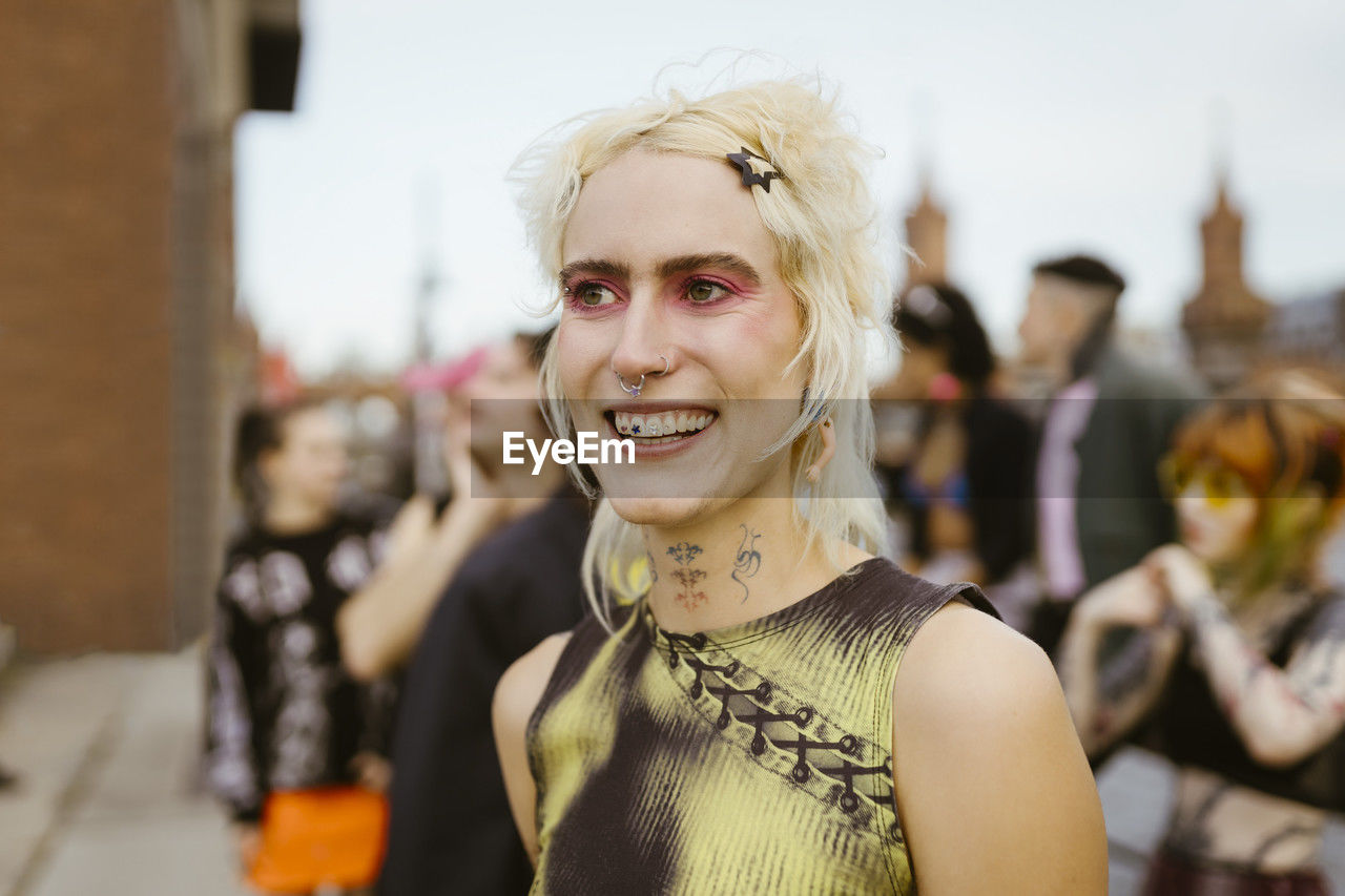 Happy non-binary person with make-up on face