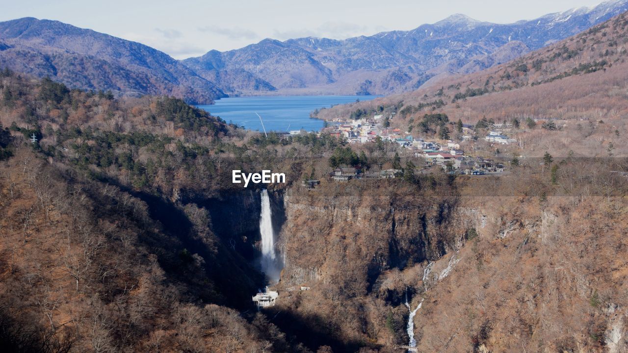 Scenic view of river amidst mountains against sky