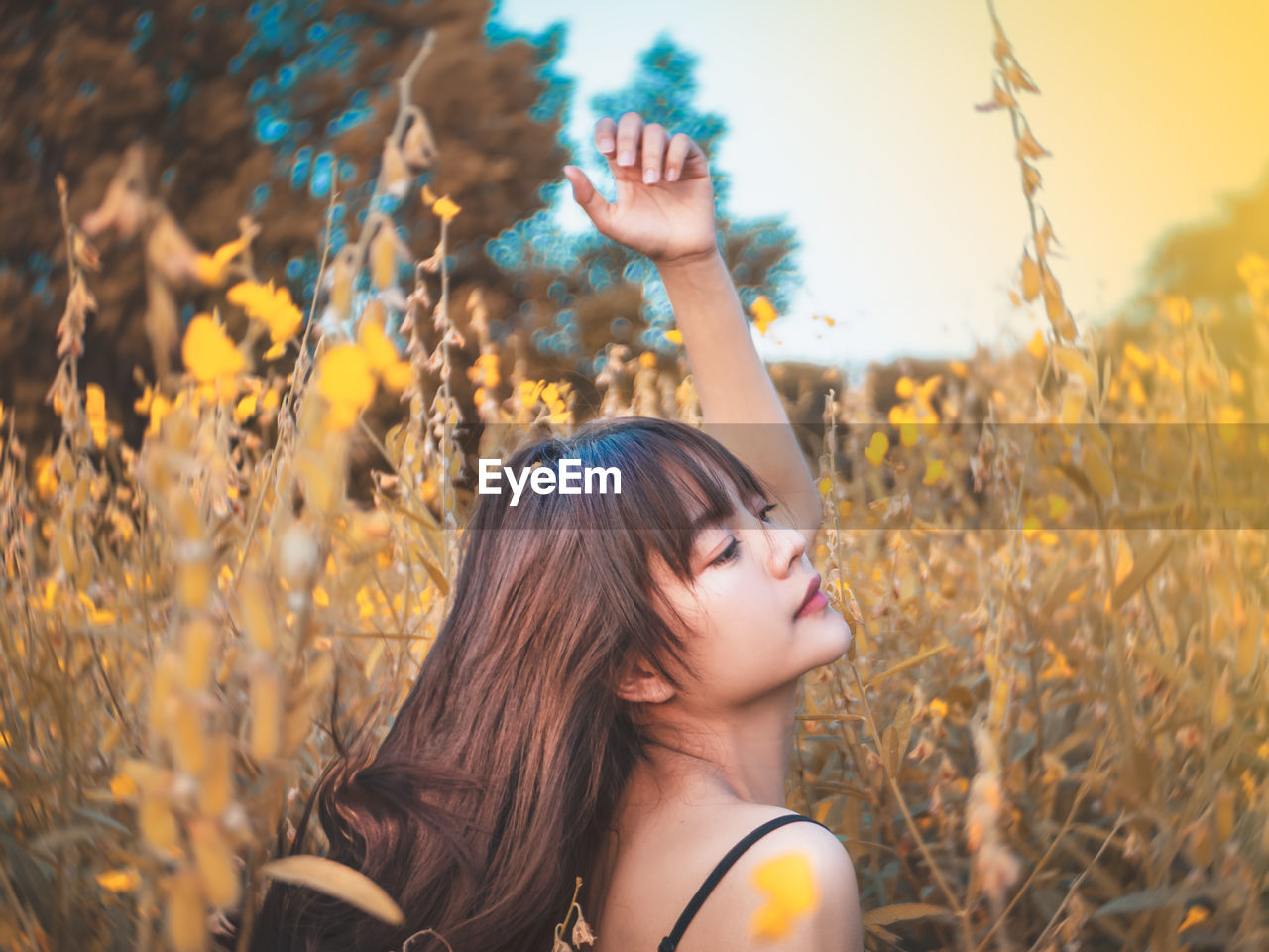 Woman looking away amidst plants