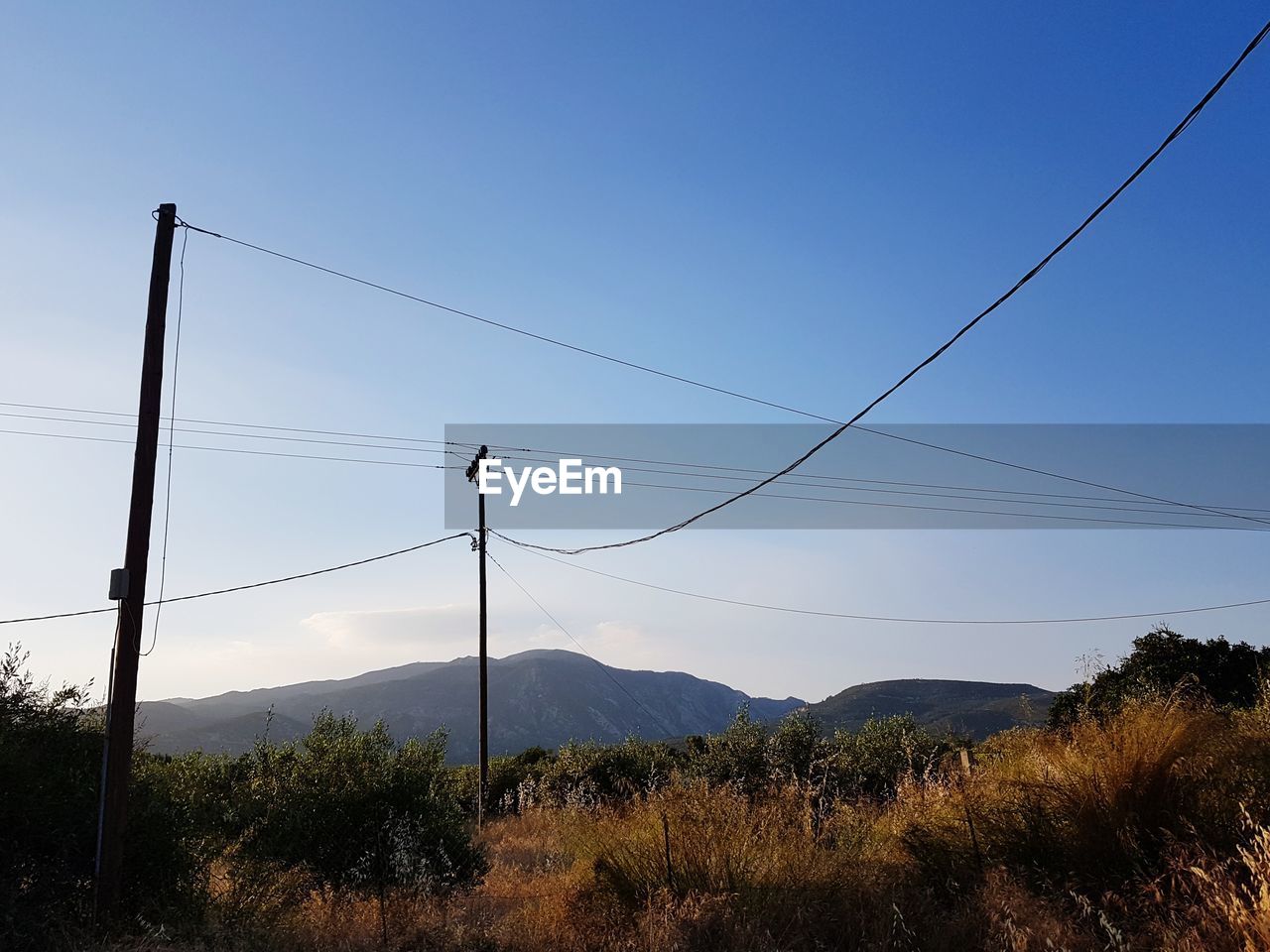 ELECTRICITY PYLON ON LAND AGAINST SKY