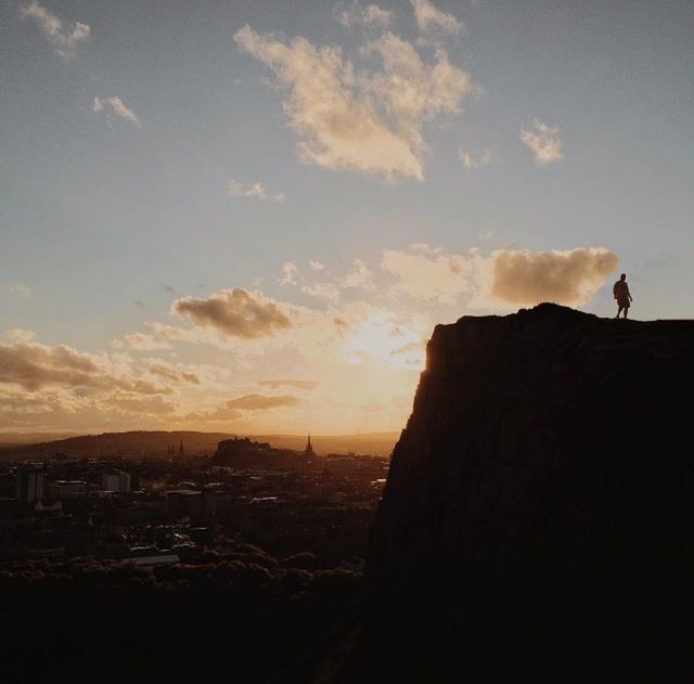 SILHOUETTE PEOPLE ON ROCK